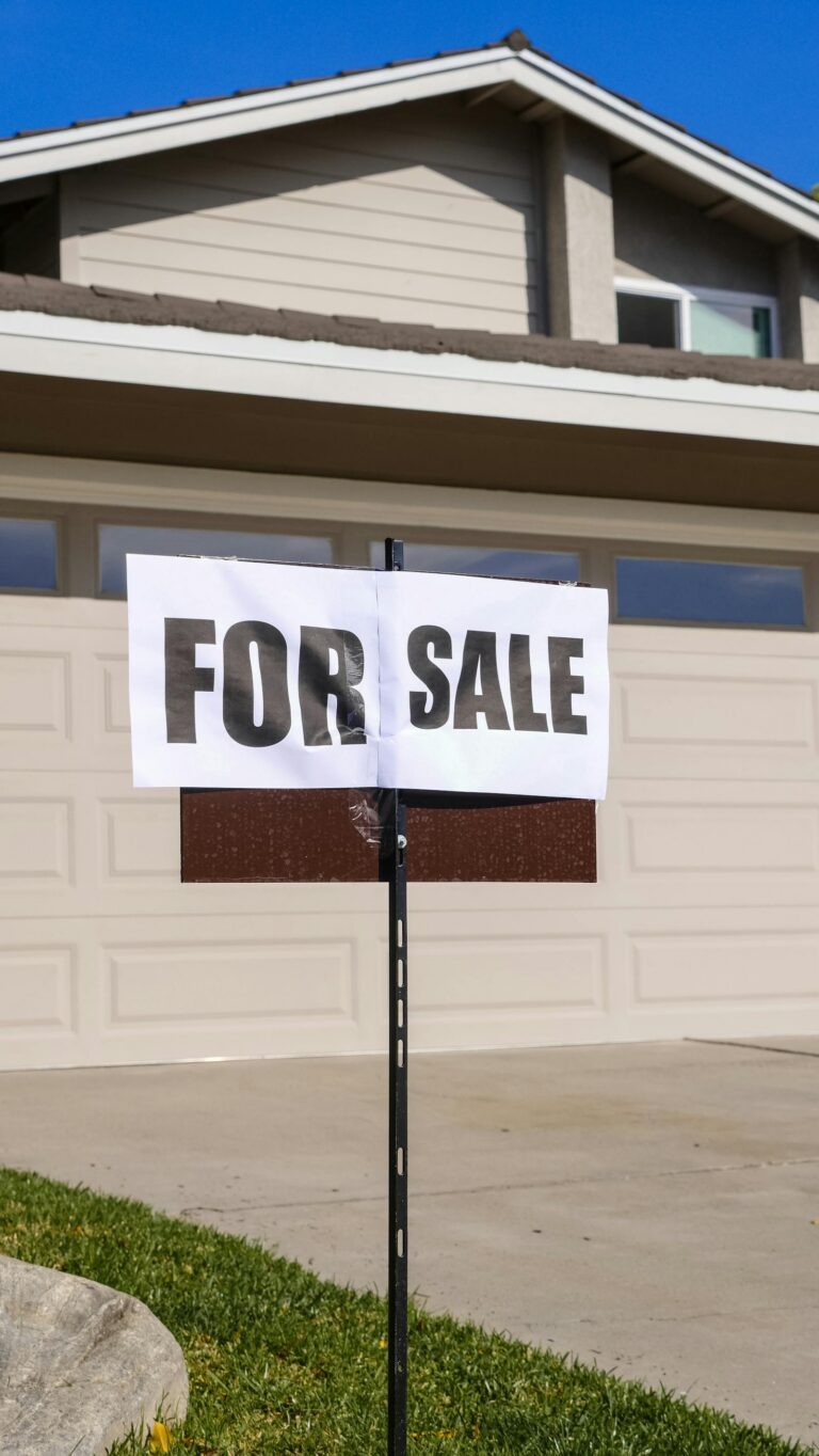 Suburban home with a For Sale sign in the front yard